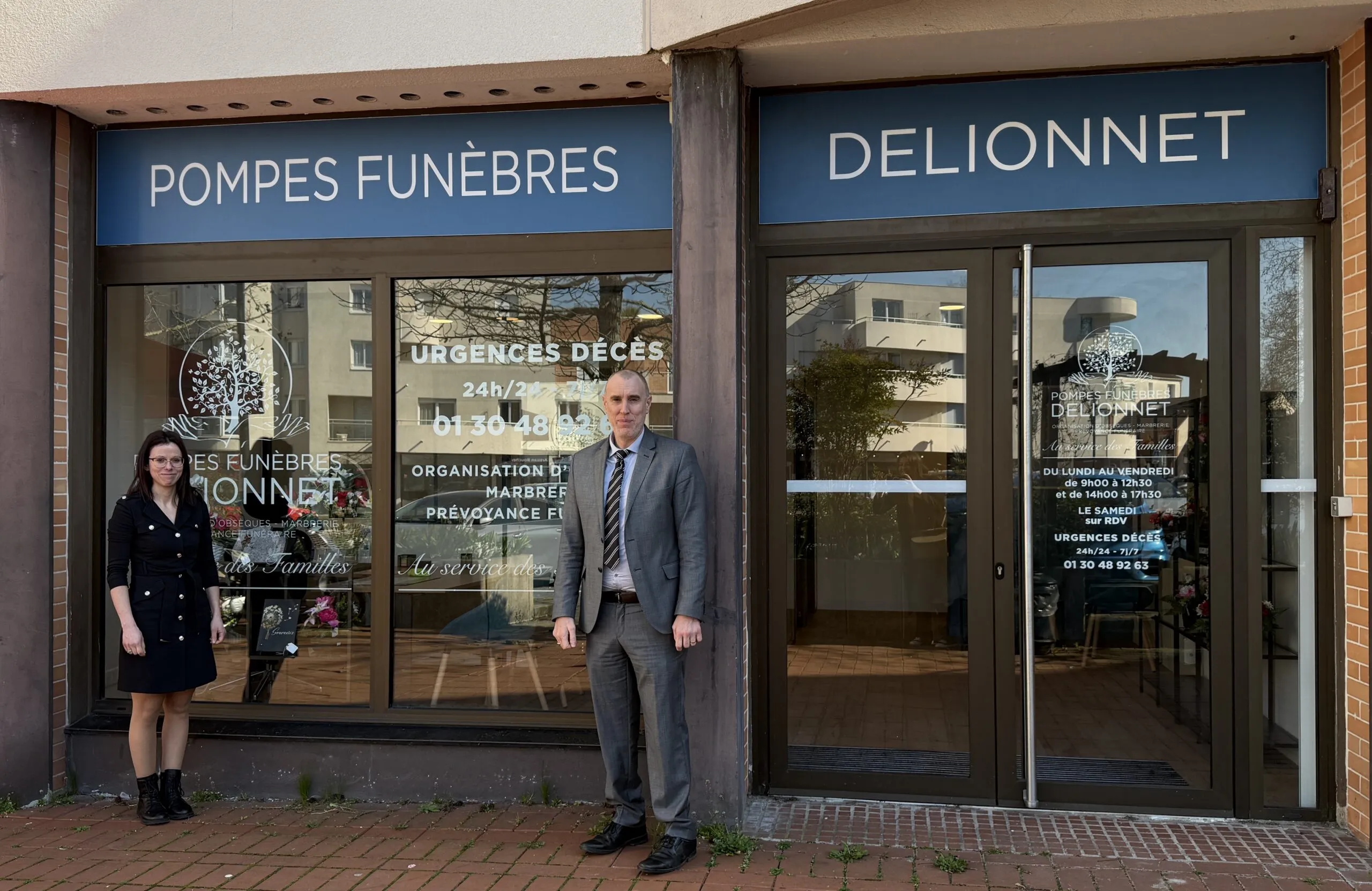 Devanture de l'agence de pompes funèbres Delionnet avec deux conseillers funéraires.
